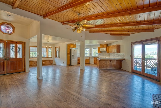 unfurnished living room featuring hardwood / wood-style floors, french doors, wood ceiling, and ceiling fan with notable chandelier