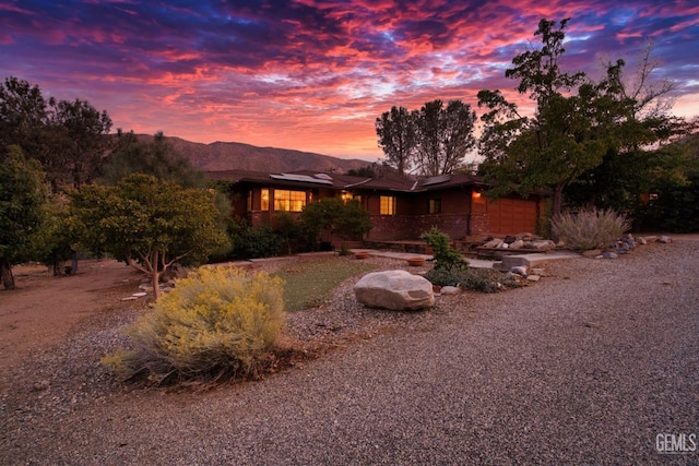 view of front of property featuring a mountain view and a garage