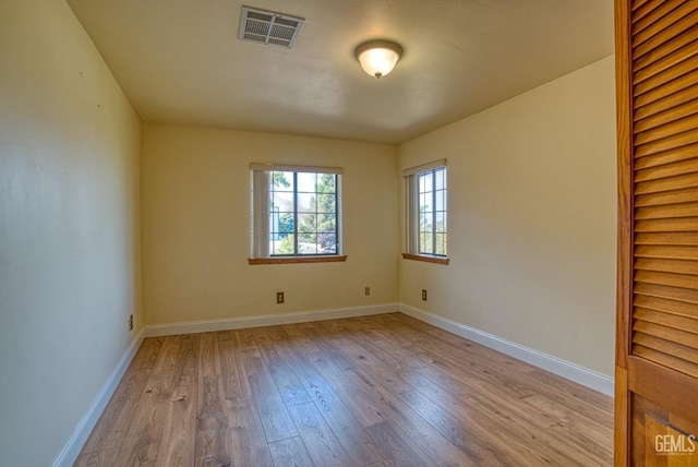 spare room with light hardwood / wood-style flooring