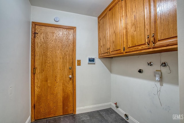 laundry area featuring gas dryer hookup, hookup for a washing machine, and cabinets