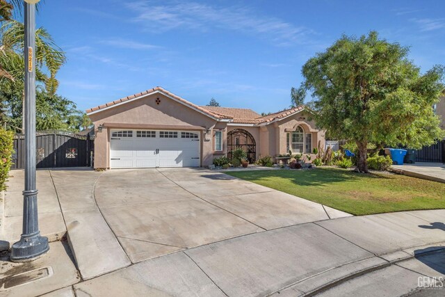 6824 Chinook Falls Dr, Bakersfield, CA 93312 - mediterranean / spanish home featuring stucco siding, a tiled roof, driveway, a garage, and a front lawn
