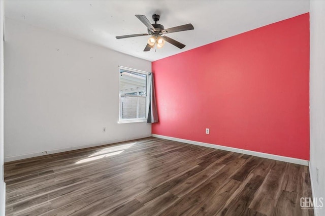 spare room featuring ceiling fan, wood finished floors, and baseboards