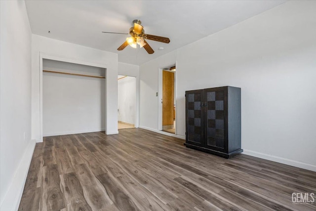 unfurnished bedroom with a closet, baseboards, and wood finished floors