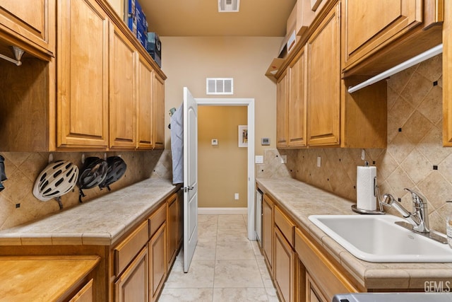2801 Trengate Way, Bakersfield, CA 93311 - kitchen with tasteful backsplash, brown cabinets, and tile countertops