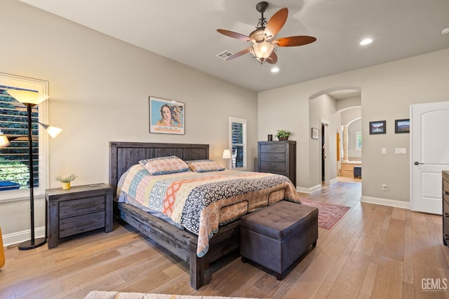2801 Trengate Way, Bakersfield, CA 93311 - bedroom featuring arched walkways, light wood-style flooring, recessed lighting, a ceiling fan, and ensuite bathroom
