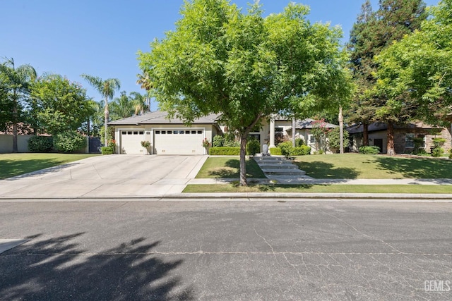 2801 Trengate Way, Bakersfield, CA 93311 - view of property hidden behind natural elements featuring driveway, a garage, and a front lawn