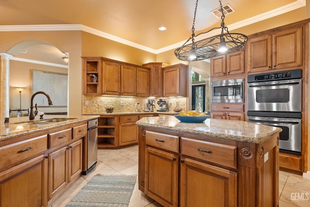 2801 Trengate Way, Bakersfield, CA 93311 - kitchen with appliances with stainless steel finishes, open shelves, arched walkways, decorative columns, and brown cabinetry
