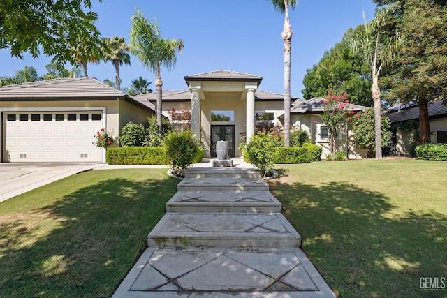 2801 Trengate Way, Bakersfield, CA 93311 - view of front of home with french doors, stucco siding, an attached garage, and a front lawn