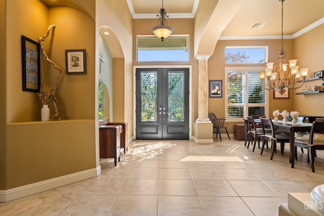 2801 Trengate Way, Bakersfield, CA 93311 - entryway featuring ornamental molding, ornate columns, a chandelier, arched walkways, and tile patterned flooring