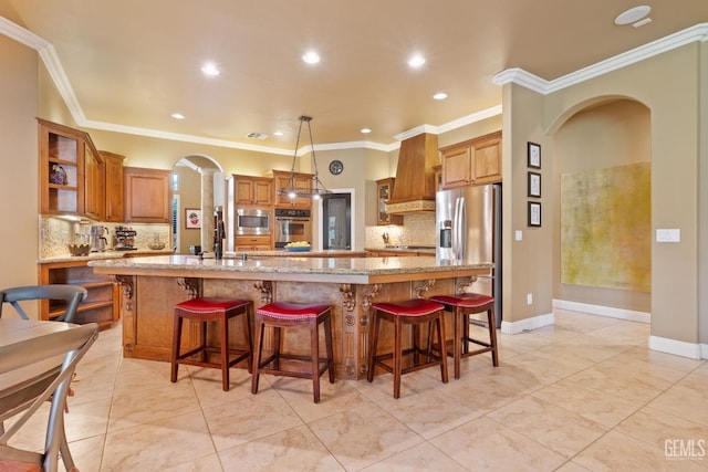 2801 Trengate Way, Bakersfield, CA 93311 - kitchen with arched walkways, appliances with stainless steel finishes, backsplash, brown cabinetry, and recessed lighting
