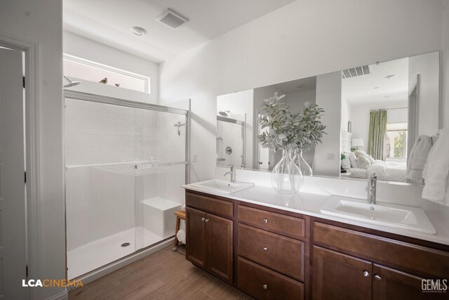 3312 Whispering Brook Ln, Shafter, CA 93263 - full bathroom with ensuite bath, a shower stall, double vanity, and wood finished floors