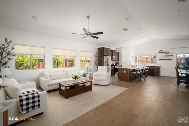 3312 Whispering Brook Ln, Shafter, CA 93263 - living area with vaulted ceiling, healthy amount of natural light, a ceiling fan, and wood finished floors