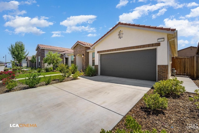 3312 Whispering Brook Ln, Shafter, CA 93263 - mediterranean / spanish home featuring stucco siding, an attached garage, driveway, and a tile roof