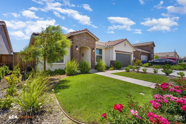 3312 Whispering Brook Ln, Shafter, CA 93263 - mediterranean / spanish-style home with a tile roof, stucco siding, an attached garage, and concrete driveway