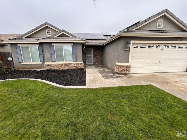 single story home featuring a garage, a front yard, and solar panels