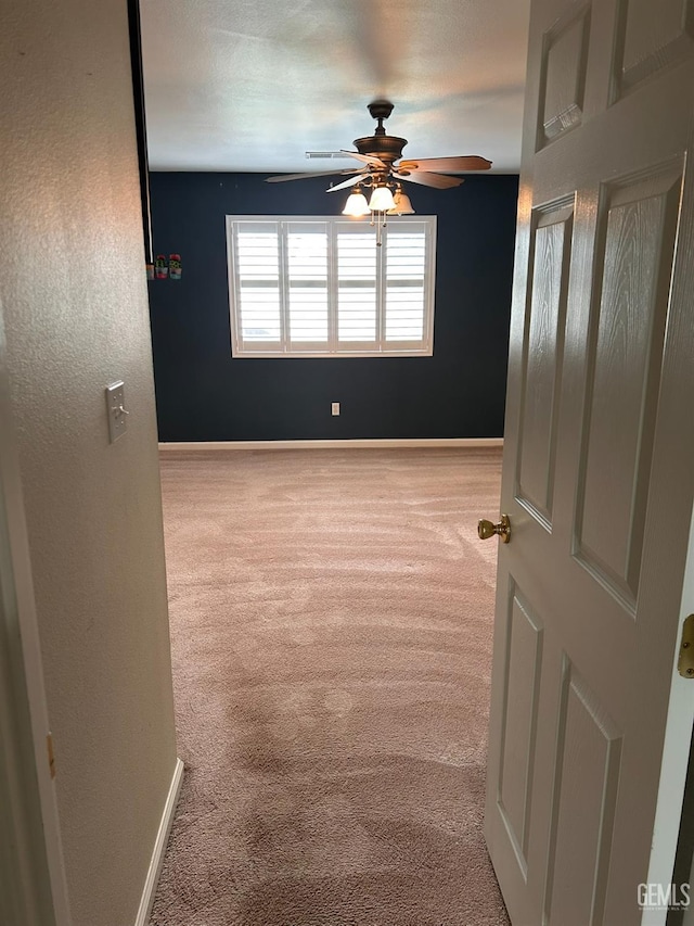 carpeted empty room with ceiling fan