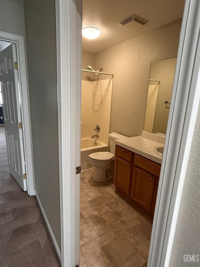 full bathroom featuring vanity, bathtub / shower combination, and toilet