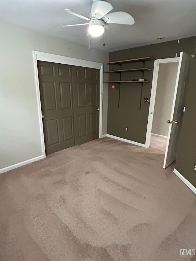 unfurnished bedroom with carpet, ceiling fan, and a closet