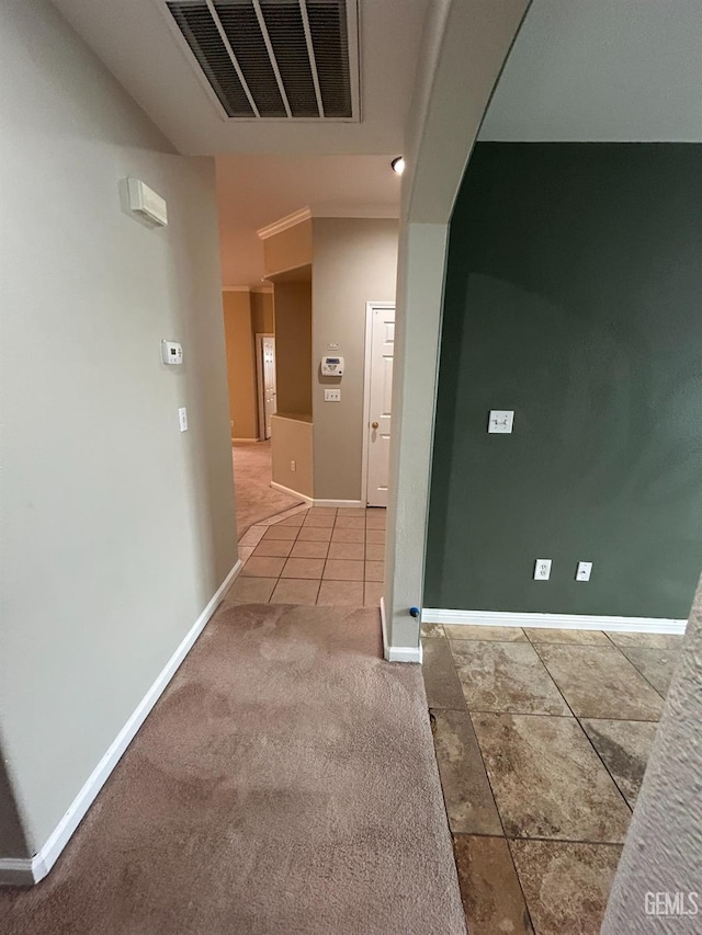 hallway featuring crown molding and tile patterned flooring