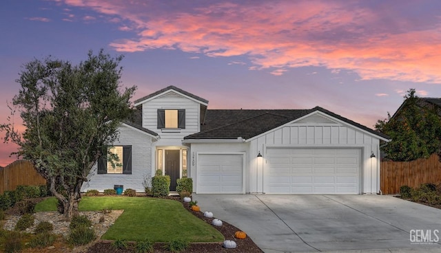 view of front property with a yard and a garage