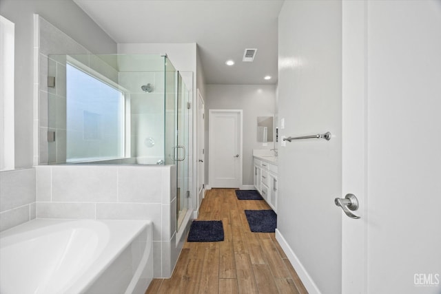 bathroom featuring vanity, shower with separate bathtub, and hardwood / wood-style flooring