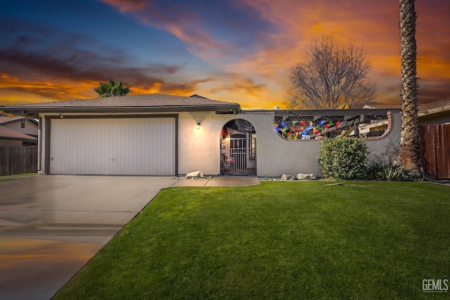 view of front of property with a garage and a yard