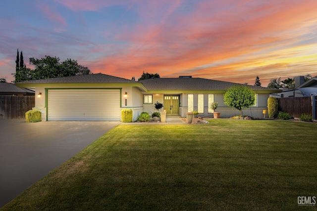 ranch-style home with concrete driveway, an attached garage, stucco siding, and french doors