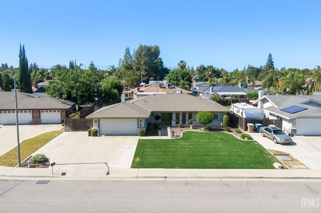 ranch-style home with concrete driveway, a residential view, and a garage