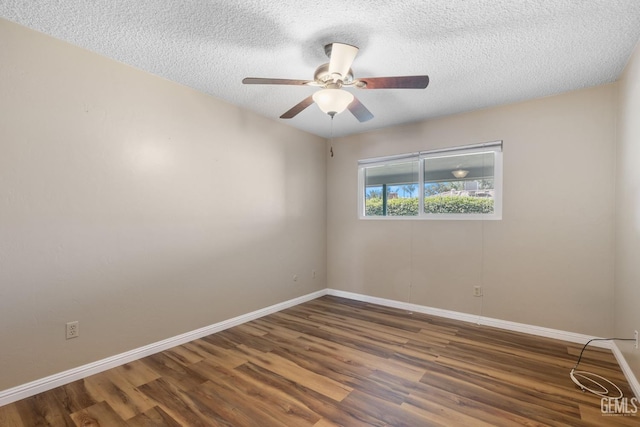 empty room with wood finished floors, baseboards, a ceiling fan, and a textured ceiling