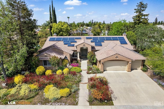 view of front of home featuring solar panels and a garage