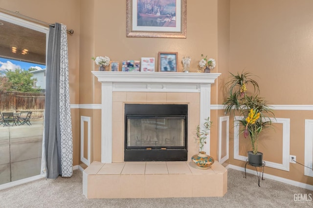 details with carpet and a tile fireplace