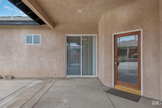 entrance to property featuring a patio area