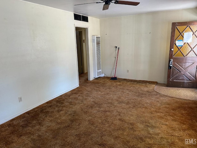 empty room with visible vents, baseboards, ceiling fan, and carpet flooring