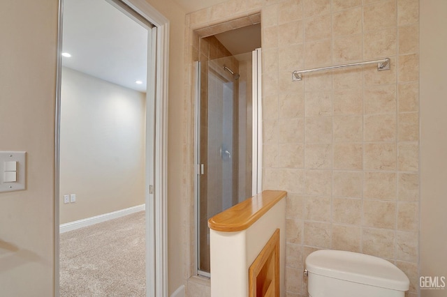 bathroom with toilet, tile walls, and walk in shower