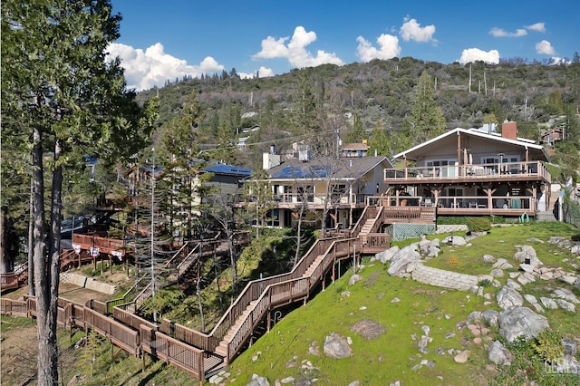 rear view of house featuring a wooden deck