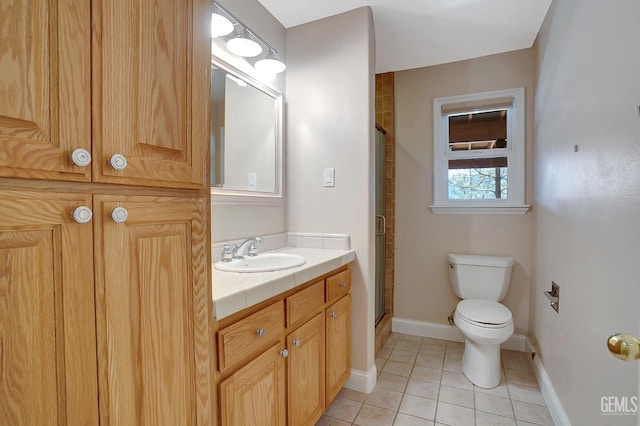 bathroom with vanity, toilet, tile patterned flooring, and walk in shower