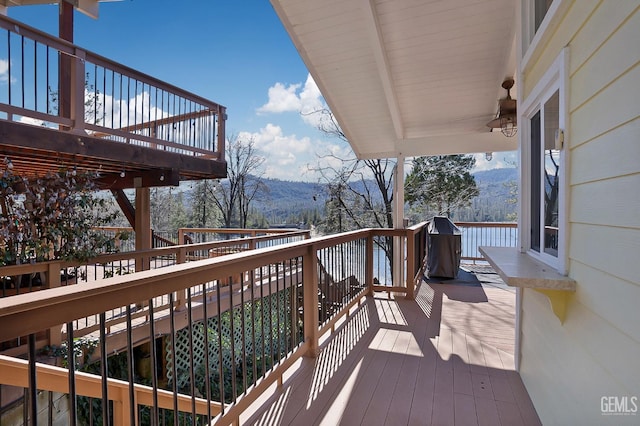 deck with a mountain view and ceiling fan