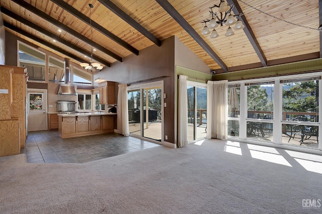 interior space with a wealth of natural light, high vaulted ceiling, a notable chandelier, light colored carpet, and pendant lighting