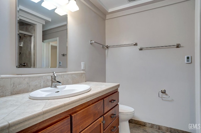 bathroom with tile patterned flooring, vanity, toilet, and a shower