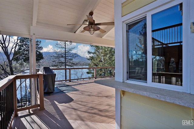 wooden terrace with a mountain view and ceiling fan