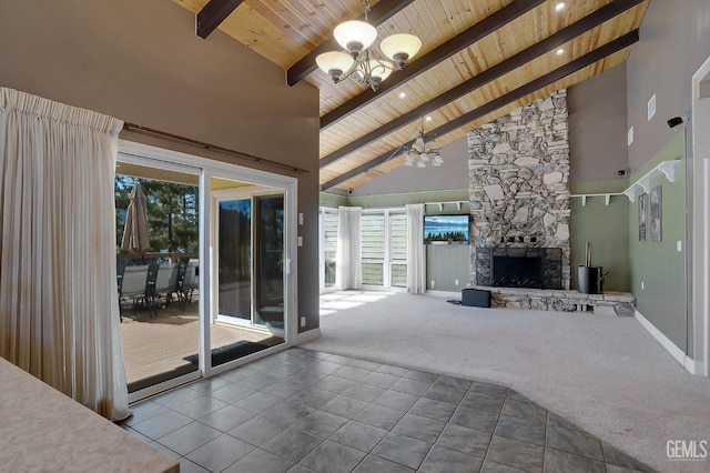 unfurnished living room with high vaulted ceiling, carpet flooring, a fireplace, a notable chandelier, and wood ceiling