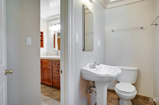 bathroom with tile patterned flooring, toilet, and sink