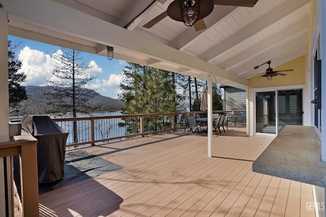 wooden terrace featuring ceiling fan and a mountain view