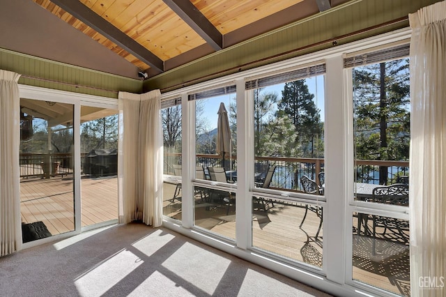 entryway with carpet flooring, vaulted ceiling with beams, and wood ceiling