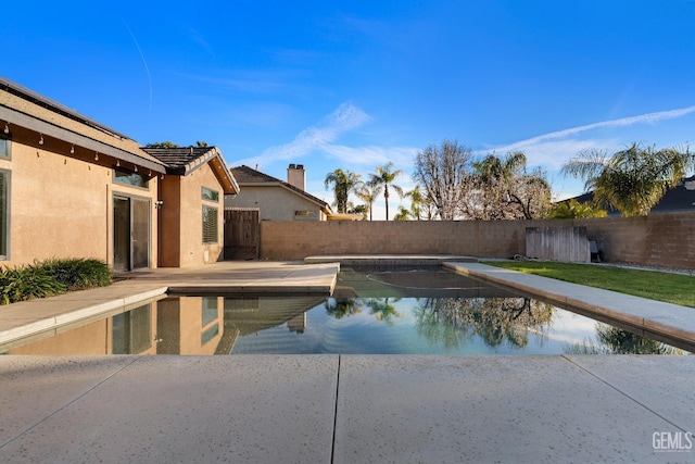 view of pool featuring a fenced backyard, a fenced in pool, and a patio