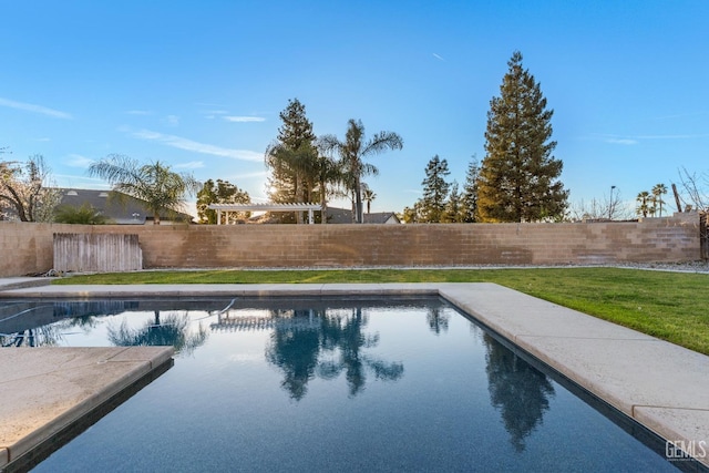 view of pool with a lawn, a fenced backyard, and a fenced in pool