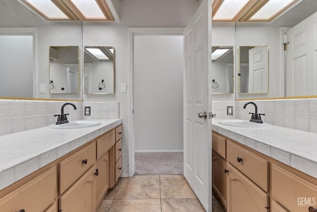 bathroom with two vanities, a sink, and decorative backsplash