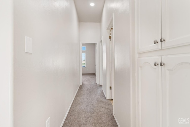 corridor with light carpet and baseboards