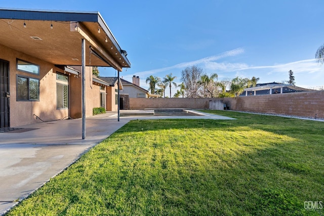 view of yard featuring a patio area and a fenced backyard