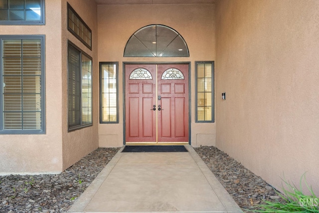 property entrance featuring stucco siding